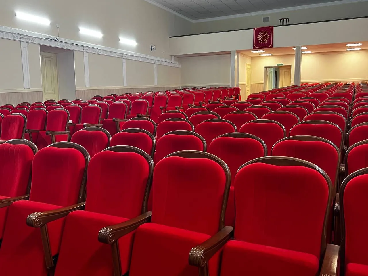 Интерьер отличается уютной атмосферой: высокие потолки, светлые фойе, стенды с фотографиями и наград