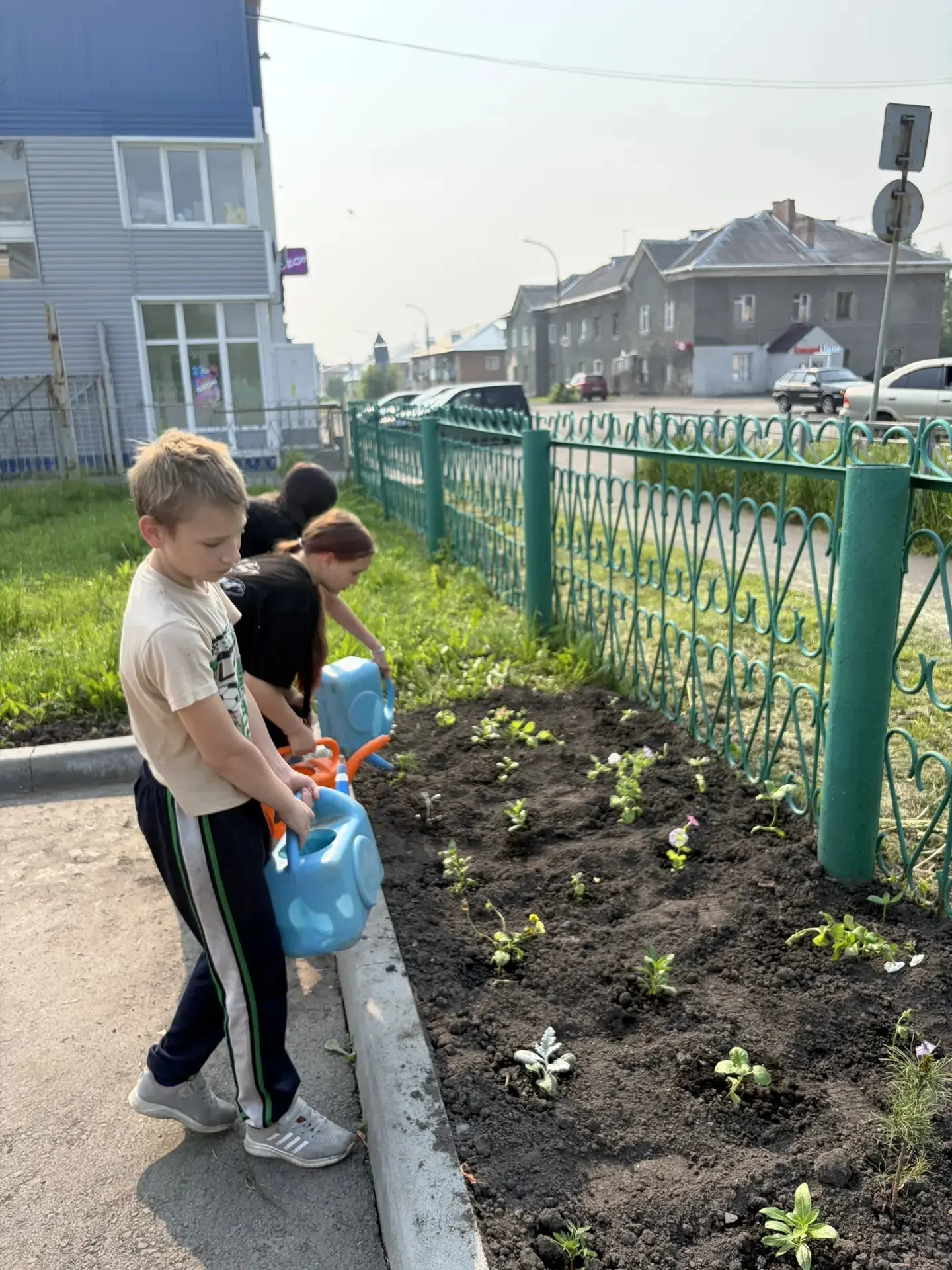 Трудовая бригада продолжает работу на пришкольном участке. Ребята собирают мусор, рыхля...