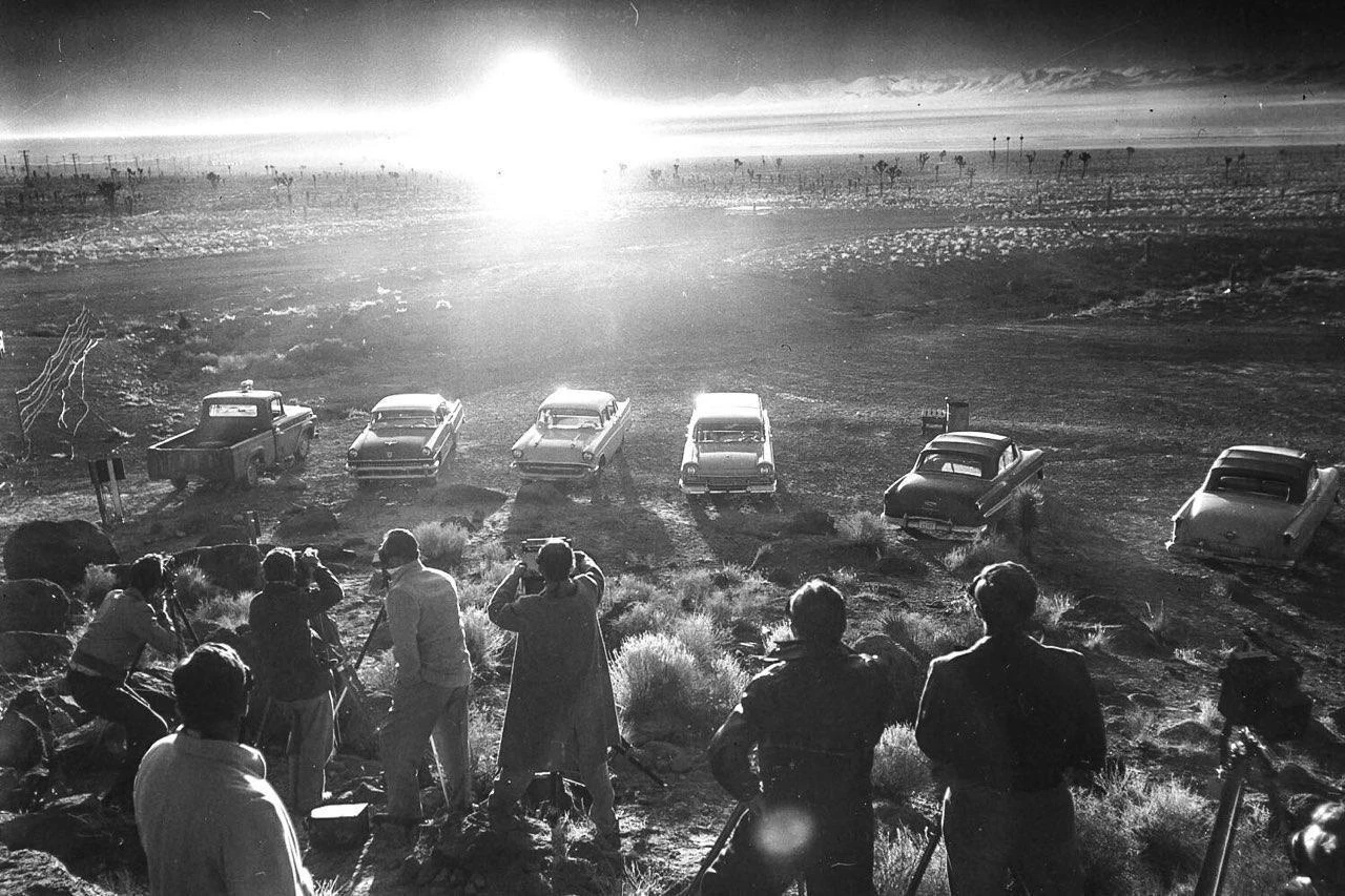 РЕПОРТЕРЫ НАБЛЮДАЮТ ЯДЕРНЫЙ ВЗРЫВ ВО ВРЕМЯ ОПЕРАЦИИ ПЛЮМБОБ, 1957 ГОД.