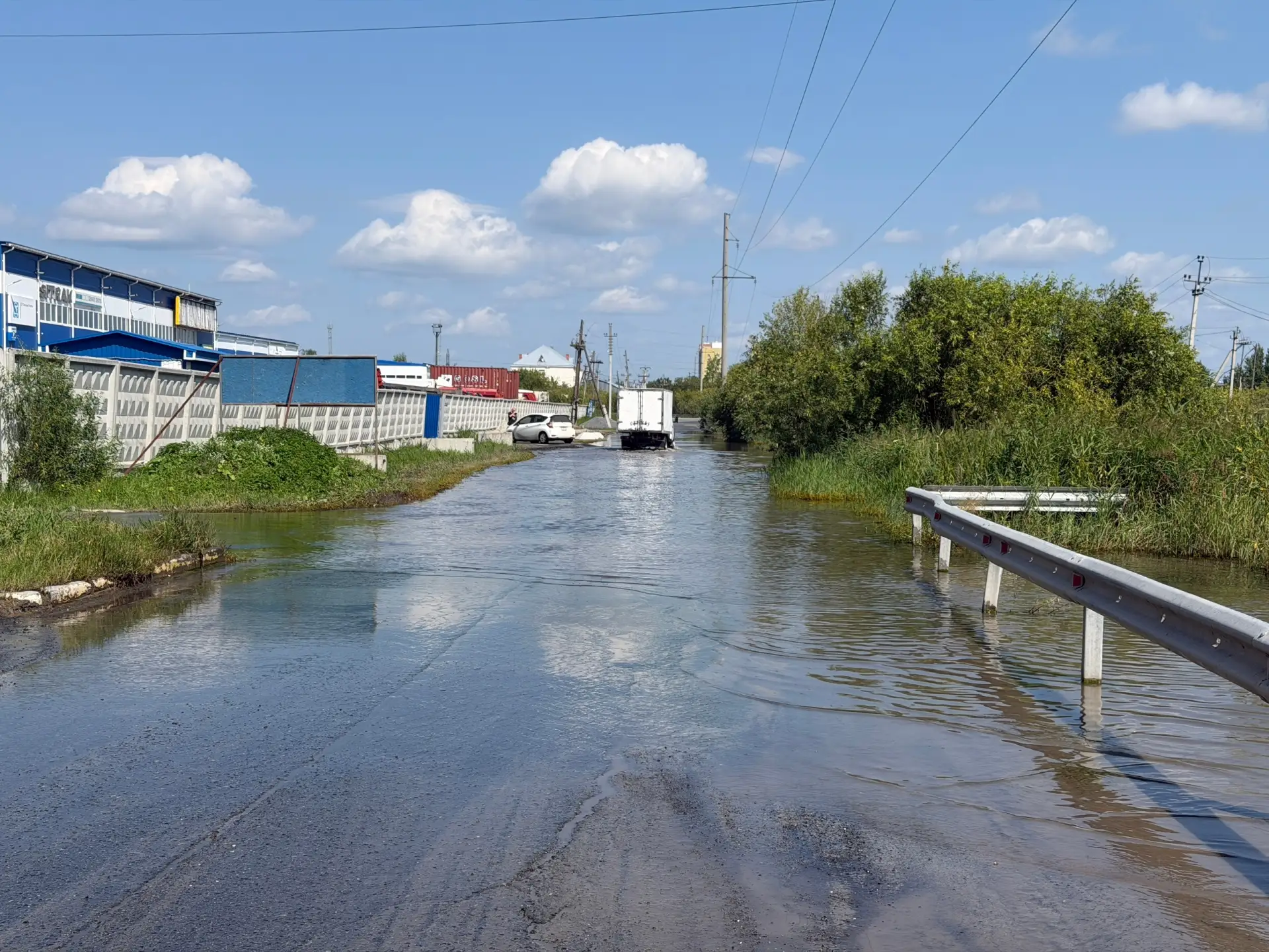 Тюмень, ул. Тимофея Чаркова, 8Г — дорога полностью в воде. Невидно ни ям, ни края проез...
