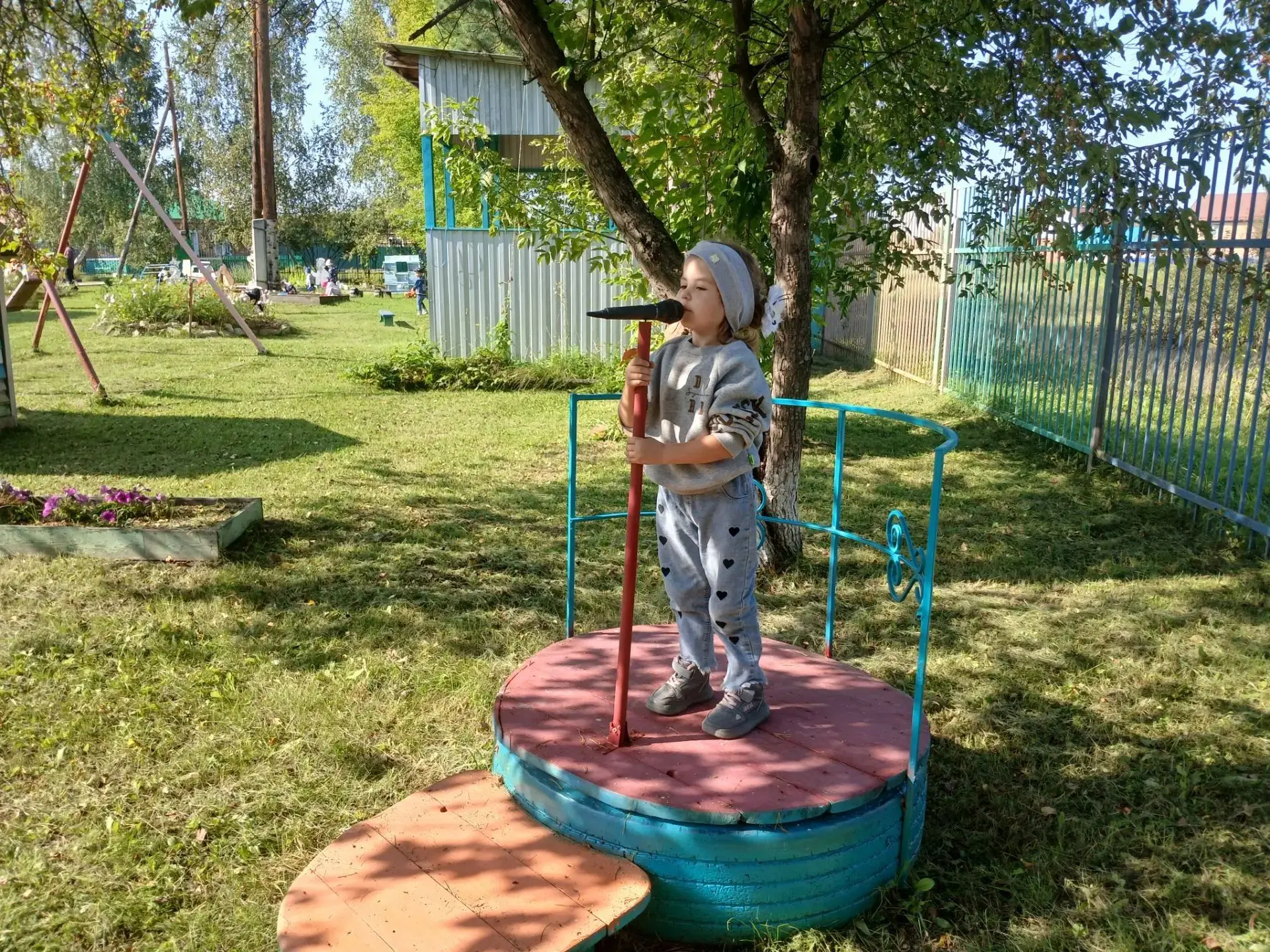 👋На фото — тёплая сцена из жизни детского сада:♥️ малыши на прогулке прощаются с летом...
