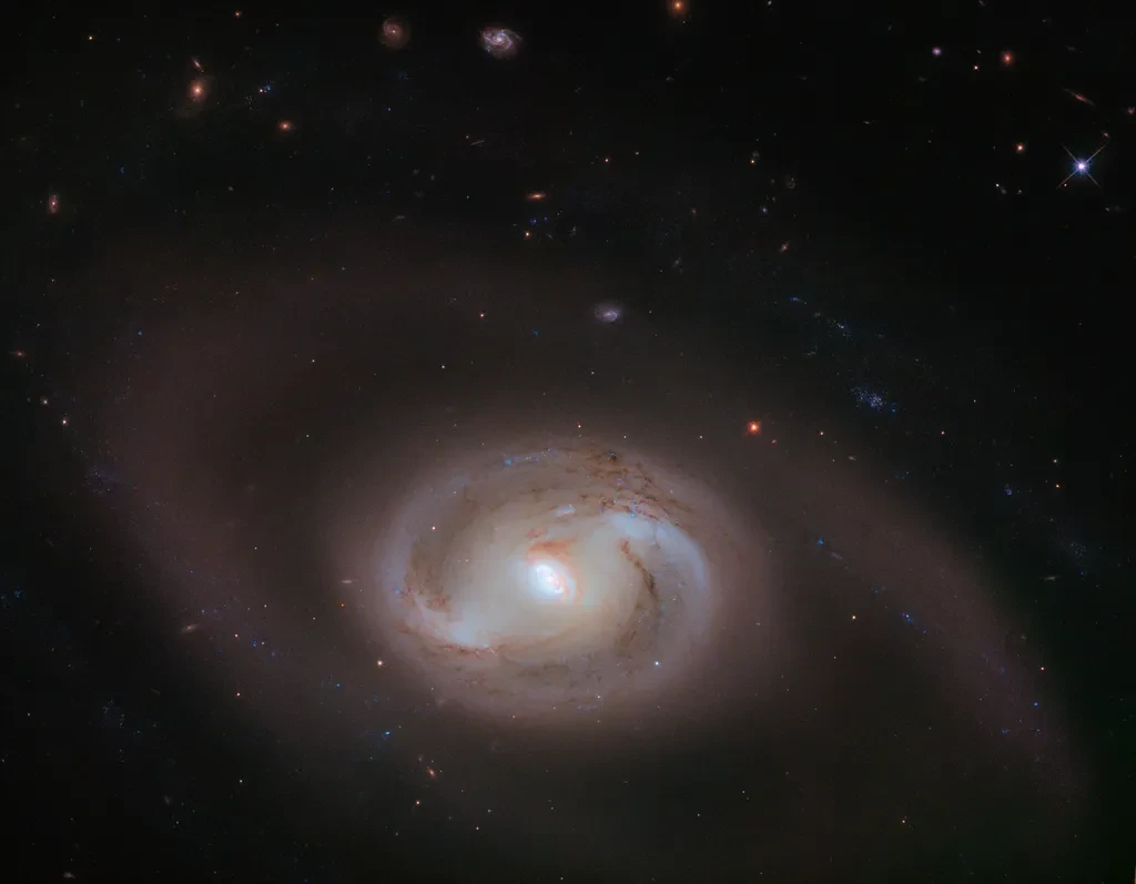 NGC 2273 на первый взгляд может показаться обычной спиралью с перемычкой, с двумя рукав...