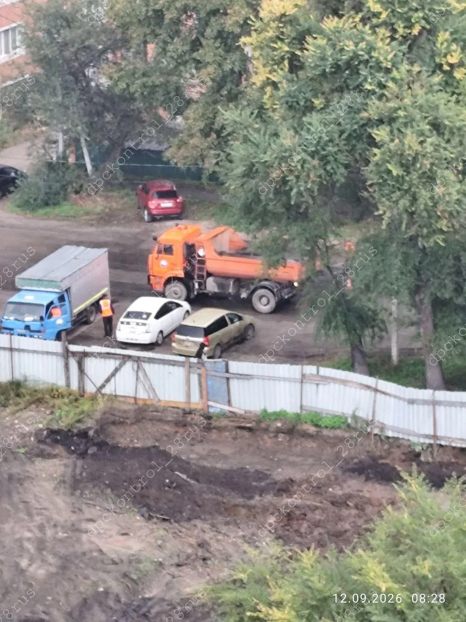 Благовещенск. 12.09.2026. ул. Партизанская. Дождь. Укладка асфальта.