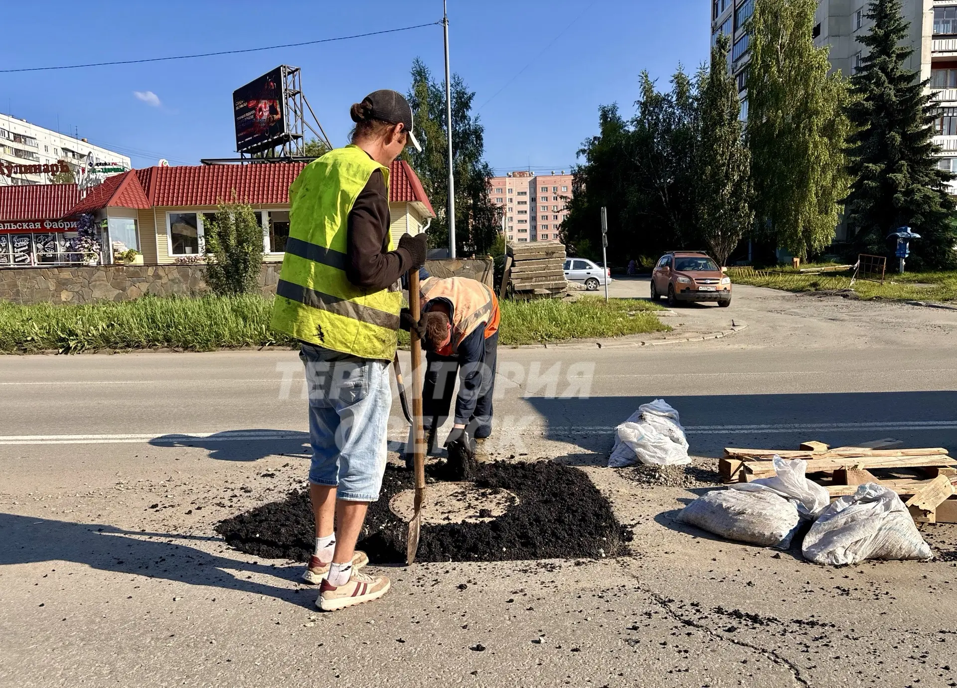 На проспекте Карла Маркса ведутся работы по асфальтированию отремонтированного колодца.