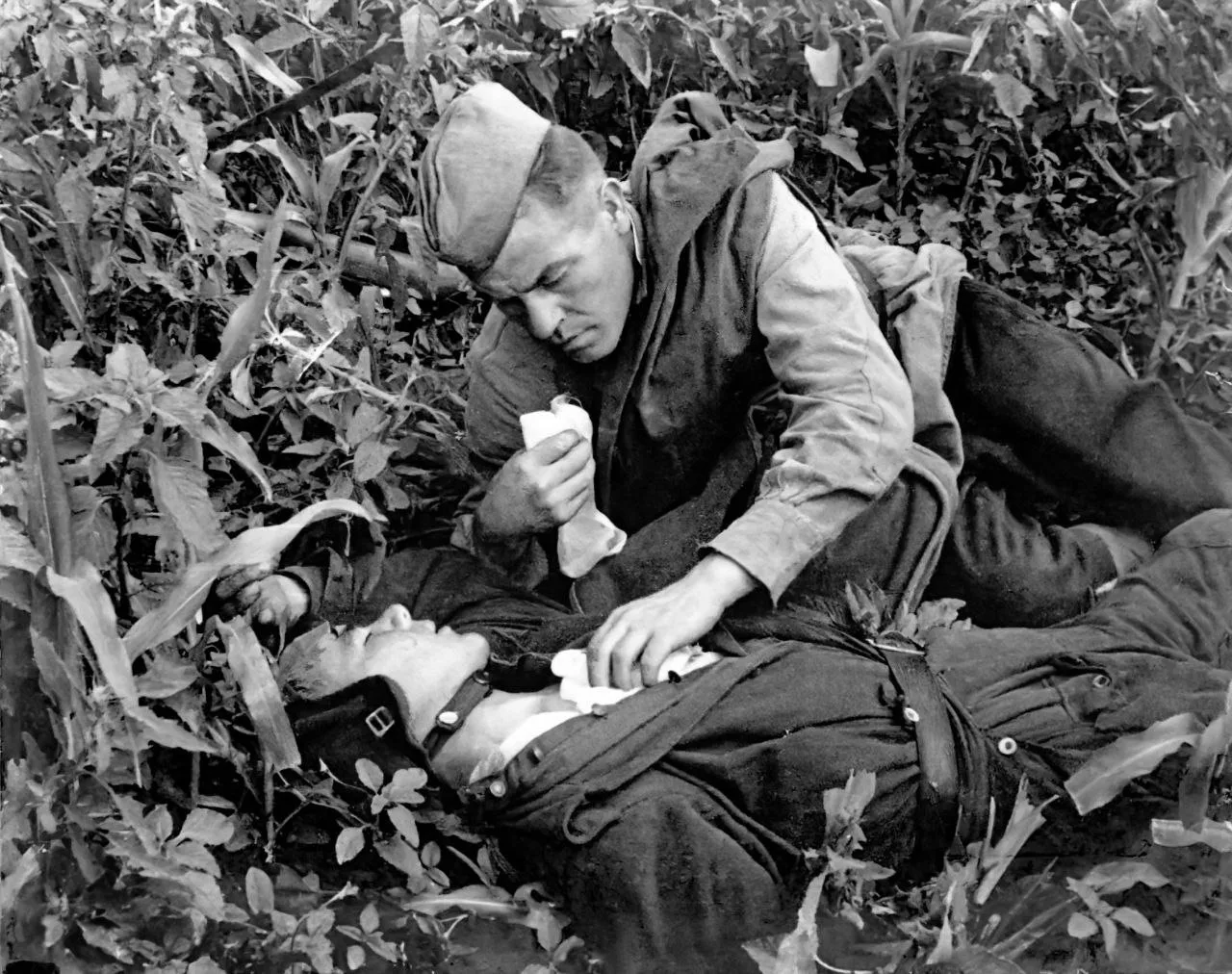 30 июля 1944 года. Близ села Изворы, Румыния. Санитар оказывает первую помощь раненому танкисту.
Фот