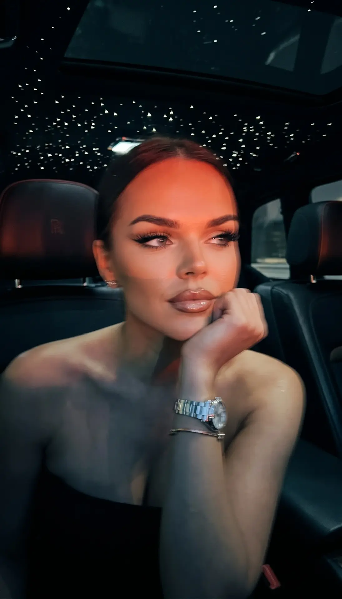 Ultra-realistic nighttime smartphone photo inside a luxury car, intimate close-up from ...