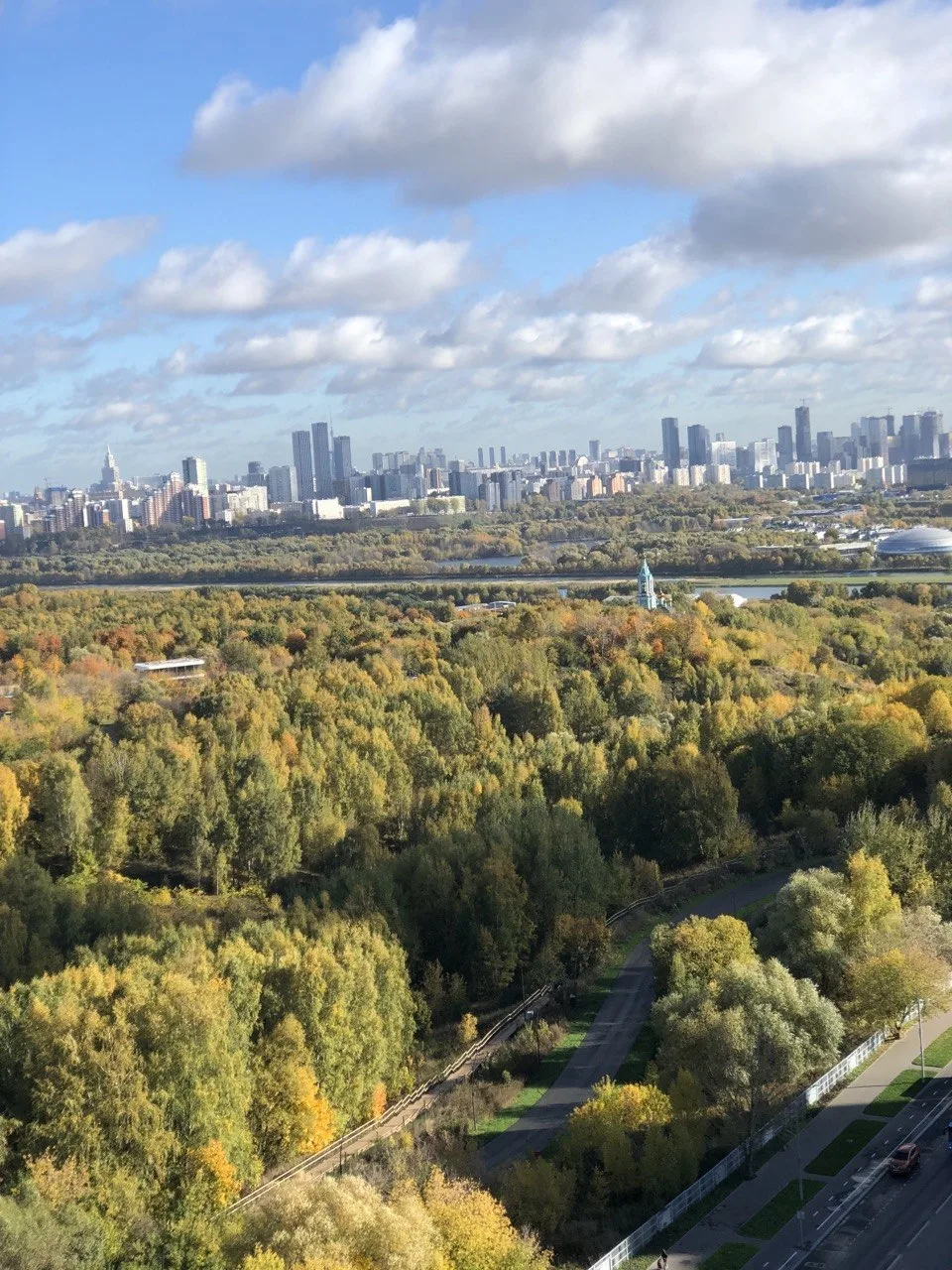 Вид на Москву из Крылатского — город вдали растворяется в золотых оттенках леса.